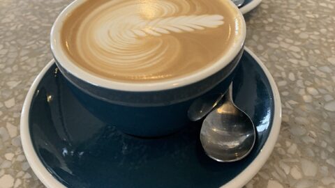 A cup of flat white coffee on a table
