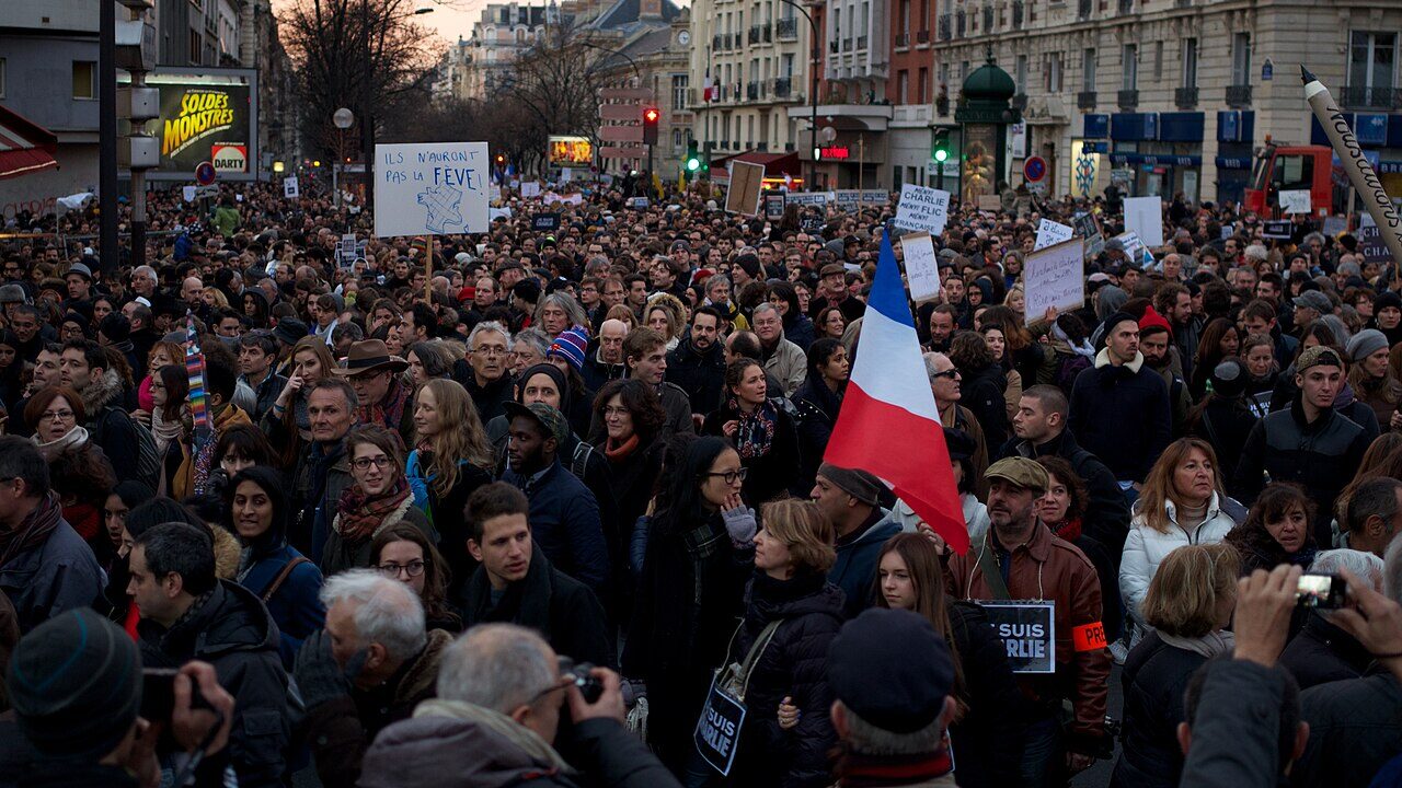 A large crowd marching in a street protest