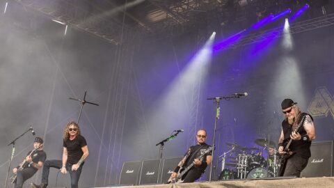 A heavy metal band performing live on a festival stage