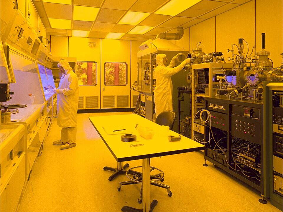 Workers inside a semiconductor fabrication cleanroom