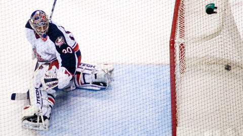 An ice hockey goaltender in position in front of the net
