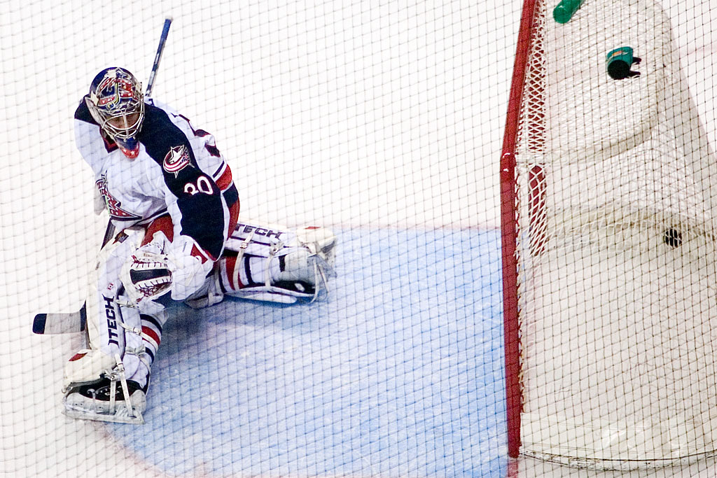 An ice hockey goaltender in position in front of the net
