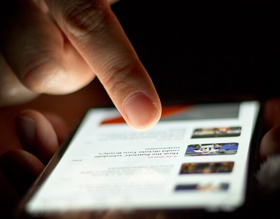 A person scrolling through a feed on a smartphone