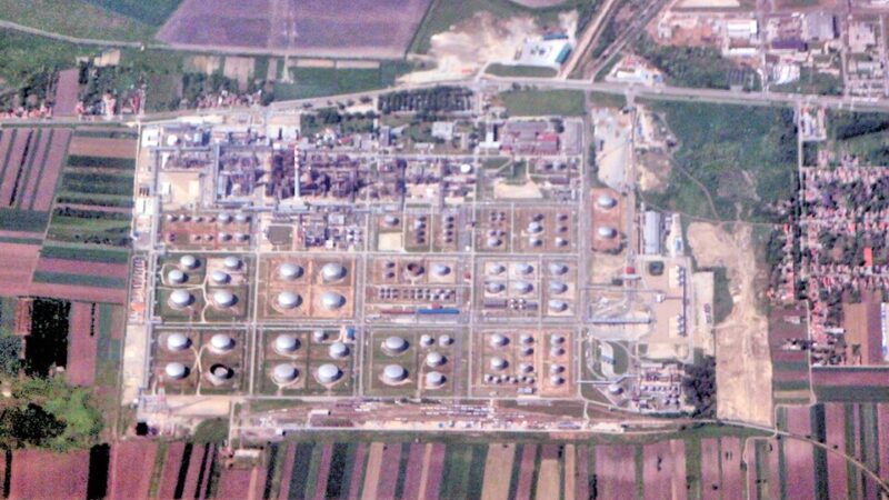 Aerial view of an oil refinery with storage tanks and processing units