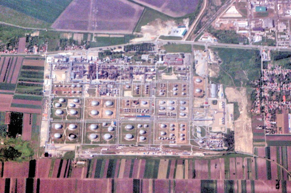 Aerial view of an oil refinery with storage tanks and processing units
