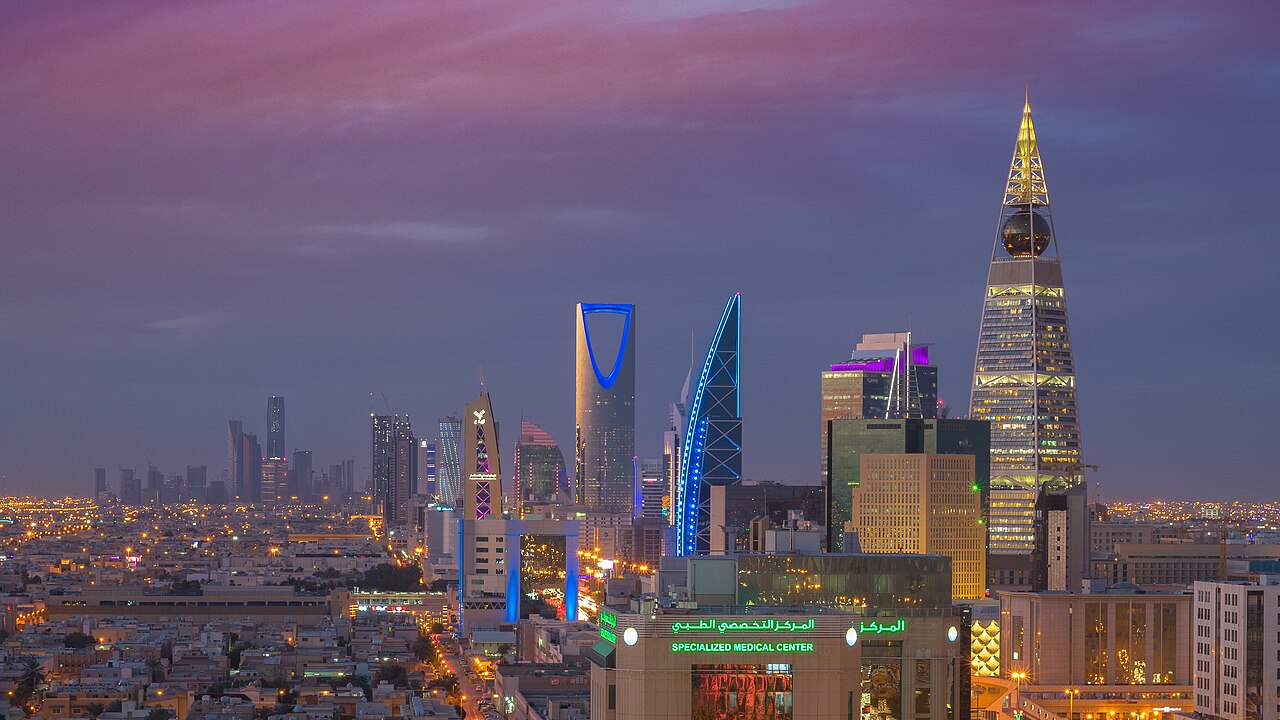 The Riyadh skyline at dusk with illuminated towers