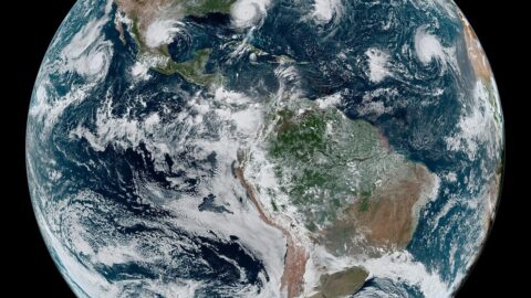 Satellite view of Earth showing storm systems over the oceans