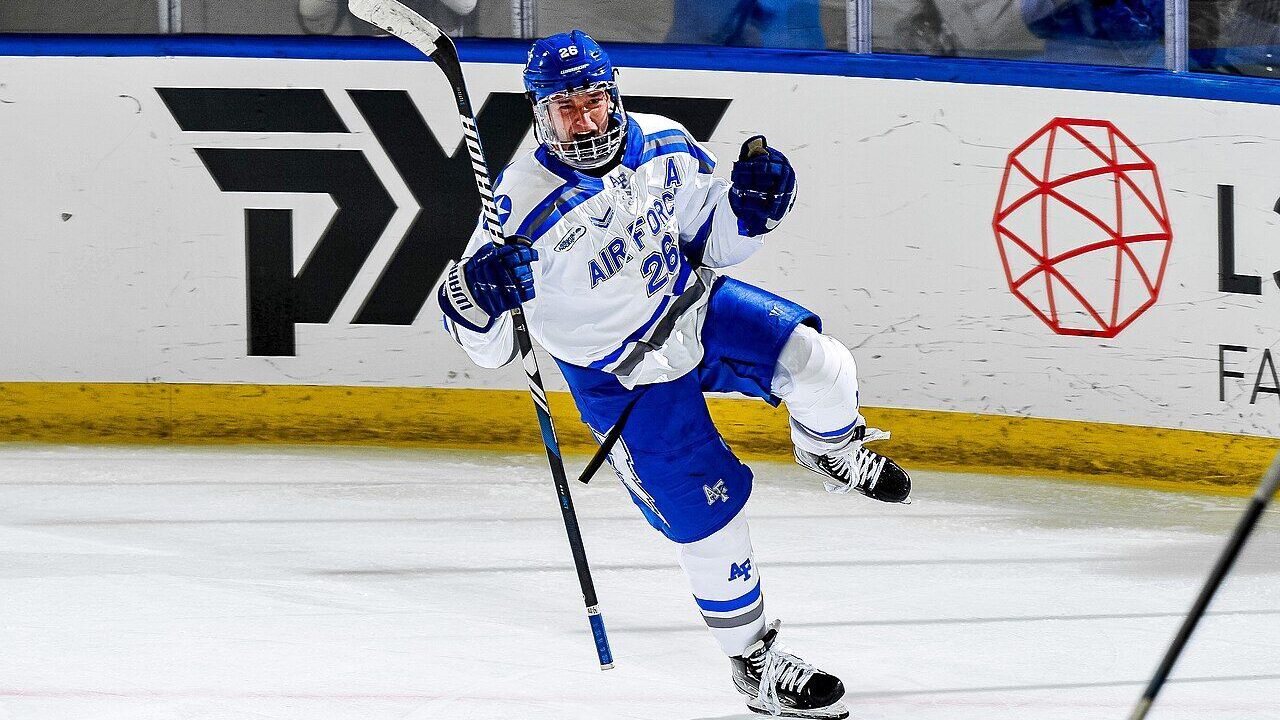 A college ice hockey player in game action