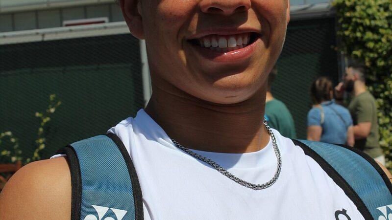 American tennis player Ben Shelton smiling at a tournament