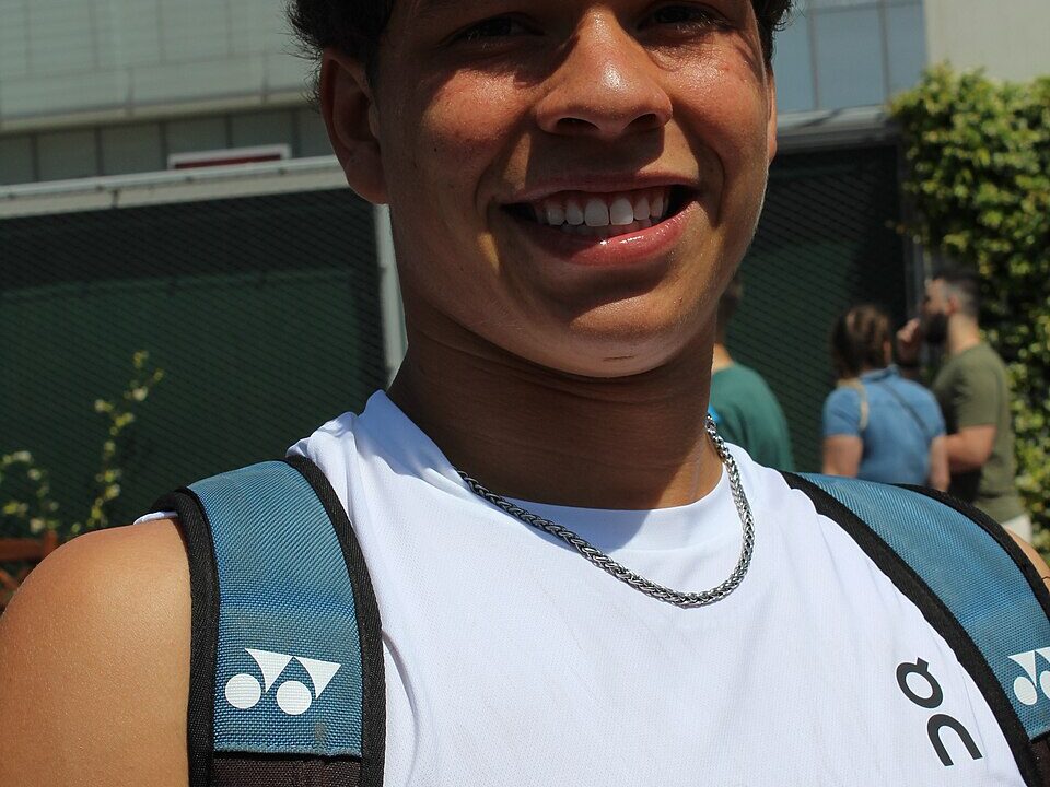 American tennis player Ben Shelton smiling at a tournament