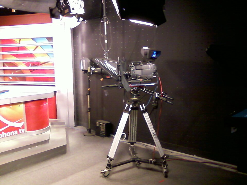 A television studio camera on a tripod in a news studio